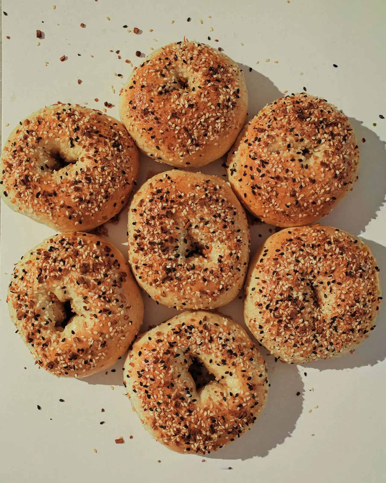 A tray of everything bagels fresh from the oven.